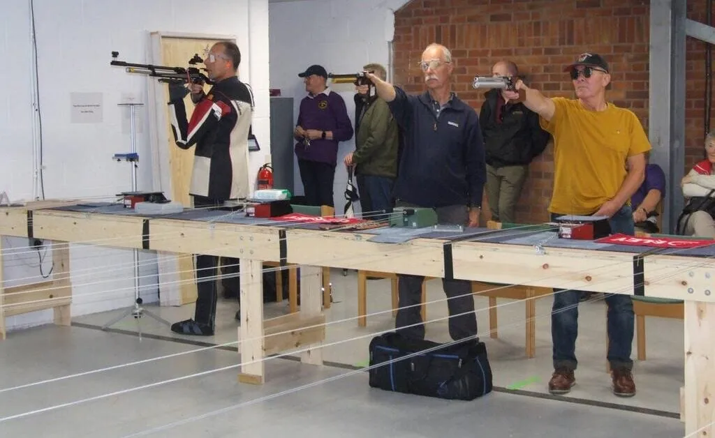 Competitor shooting in the standing position at Pinhoe TSC's 10m Air Pistol Open.
